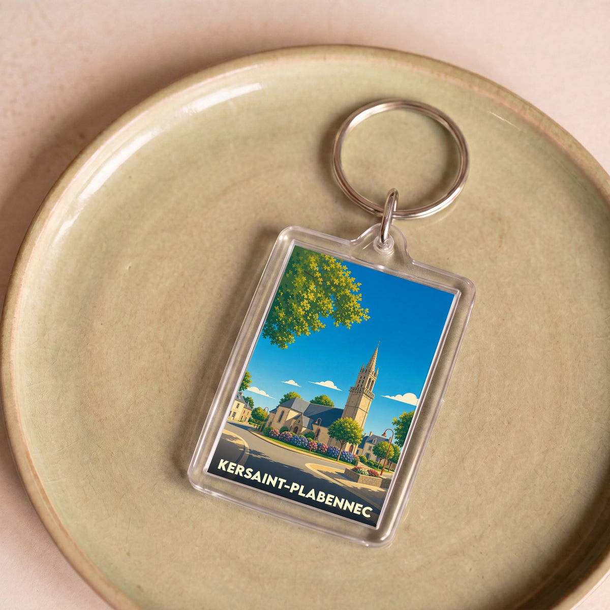 Porte-clés souvenir de la ville de Kersaint-Plabennec avec une illustration stylisée.
