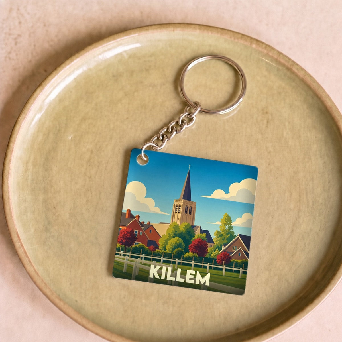 Porte-clés souvenir de la ville de Killem avec une illustration stylisée.