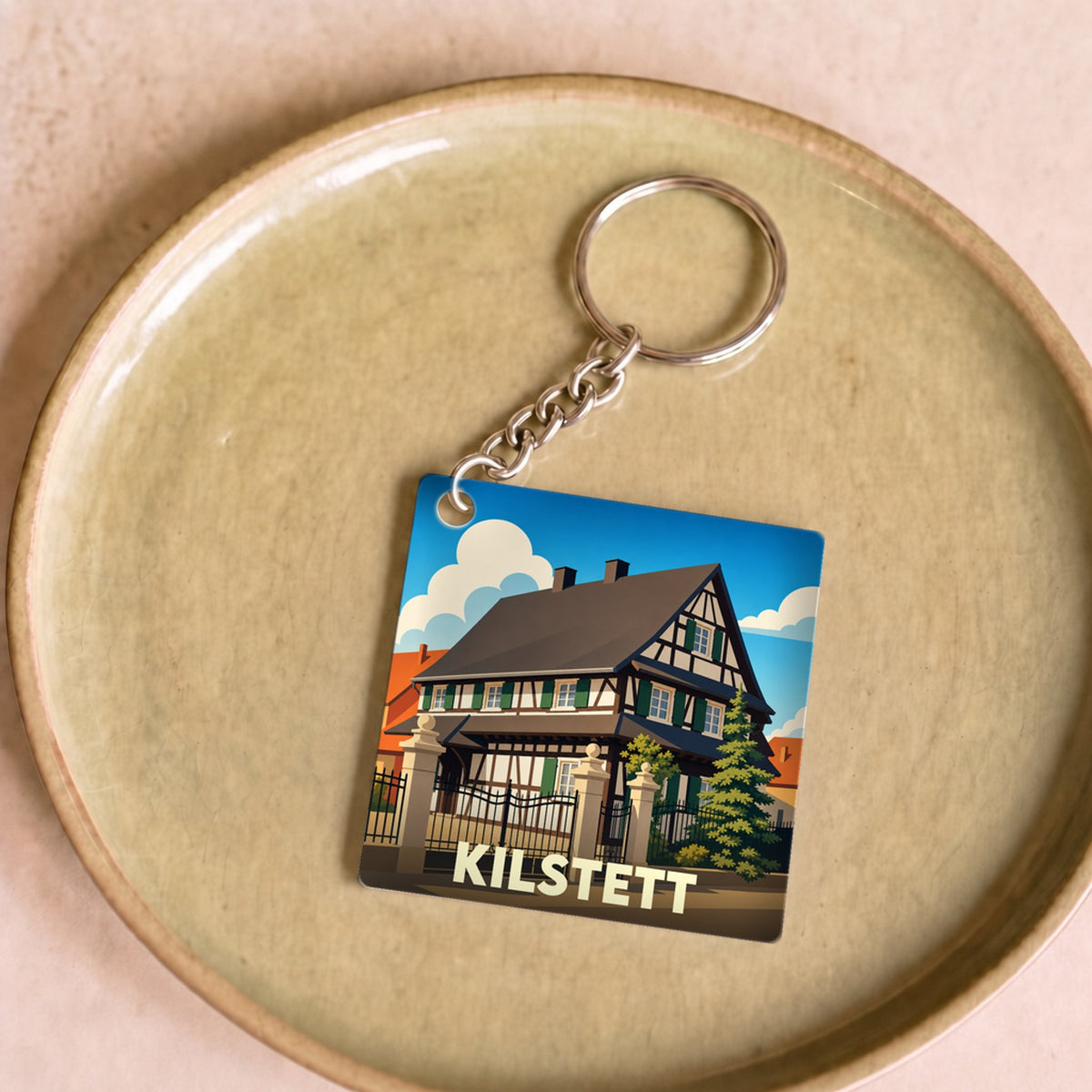 Porte-clés souvenir de la ville de Kilstett avec une illustration stylisée d'une maison à colombages.
