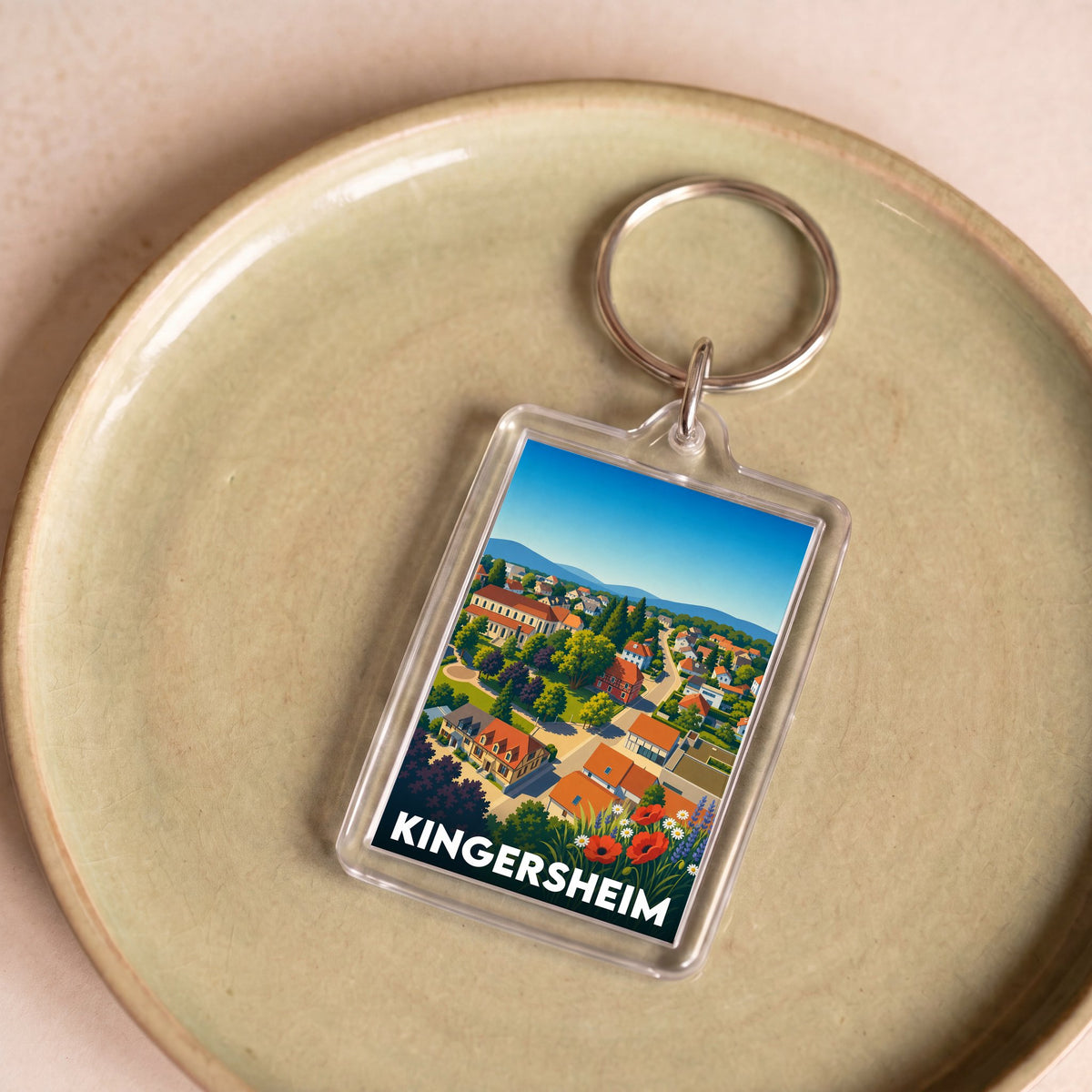 Porte-clés souvenir de la ville de Kingersheim avec une illustration stylisée.