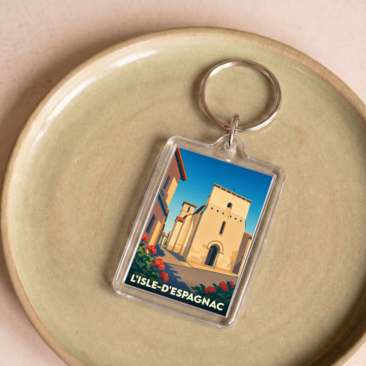 Porte-clés souvenir de la ville de L'Isle-d'Espagnac avec une illustration stylisée de son église.