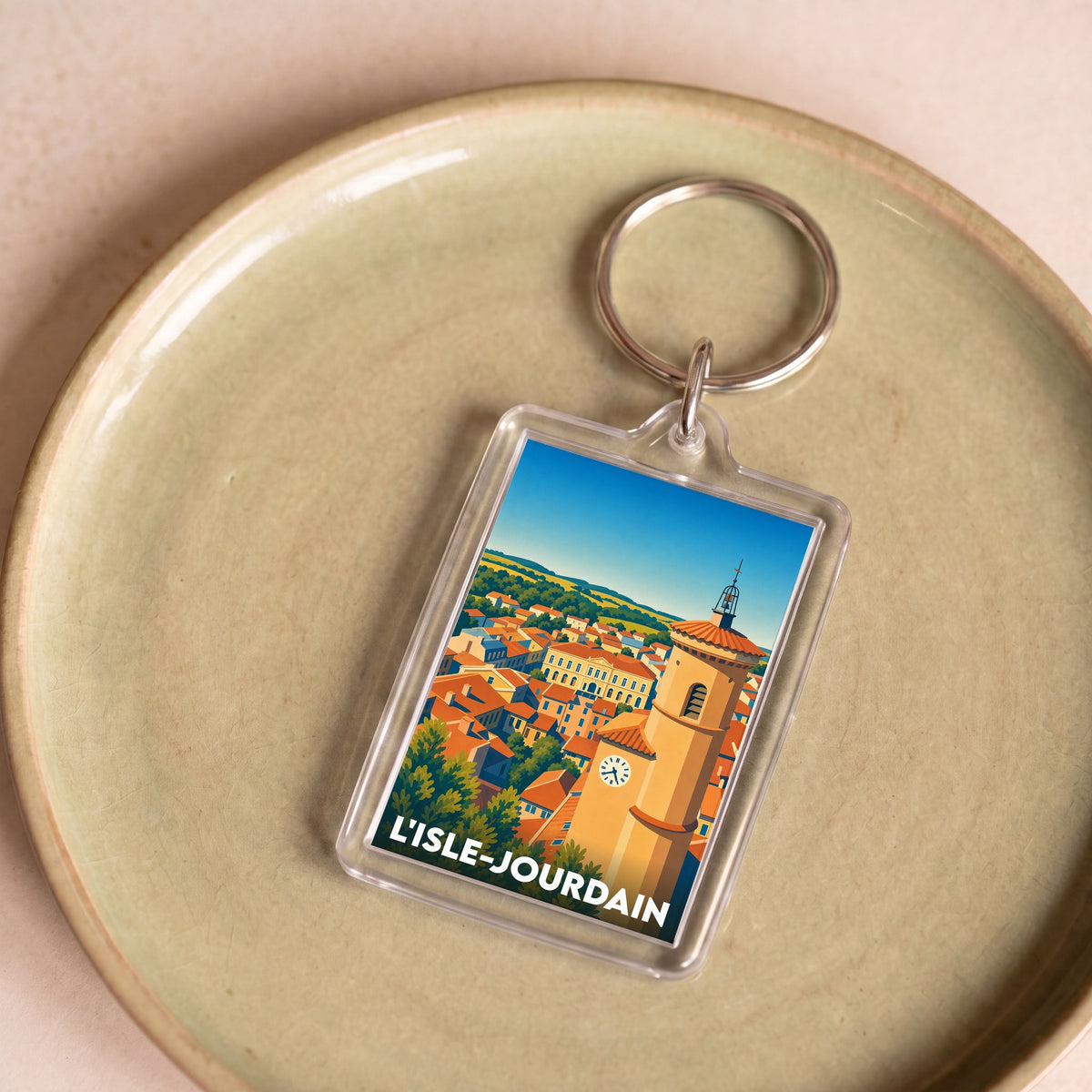 Porte-clés souvenir de la ville de L'Isle-Jourdain avec une illustration stylisée.