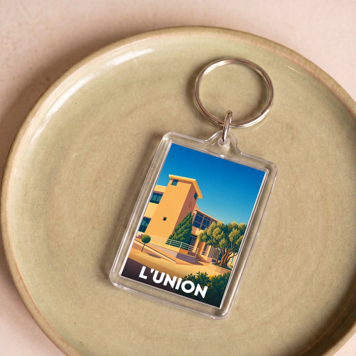 Porte-clés souvenir de la ville de L'Union avec une illustration stylisée.