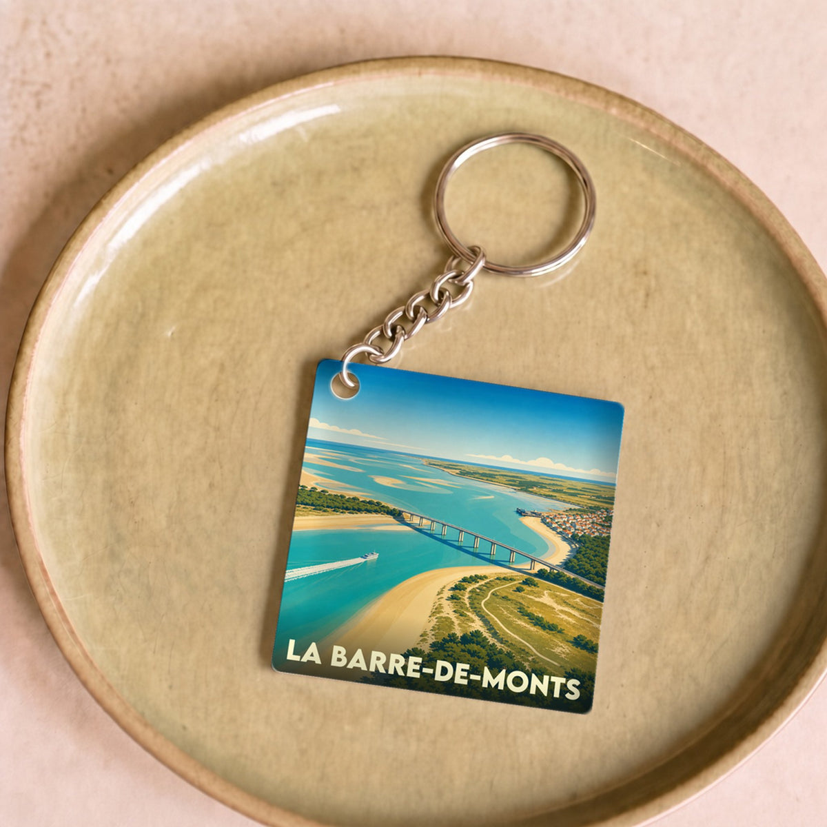 Porte-clés souvenir de la ville de La Barre-de-Monts avec une illustration stylisée.