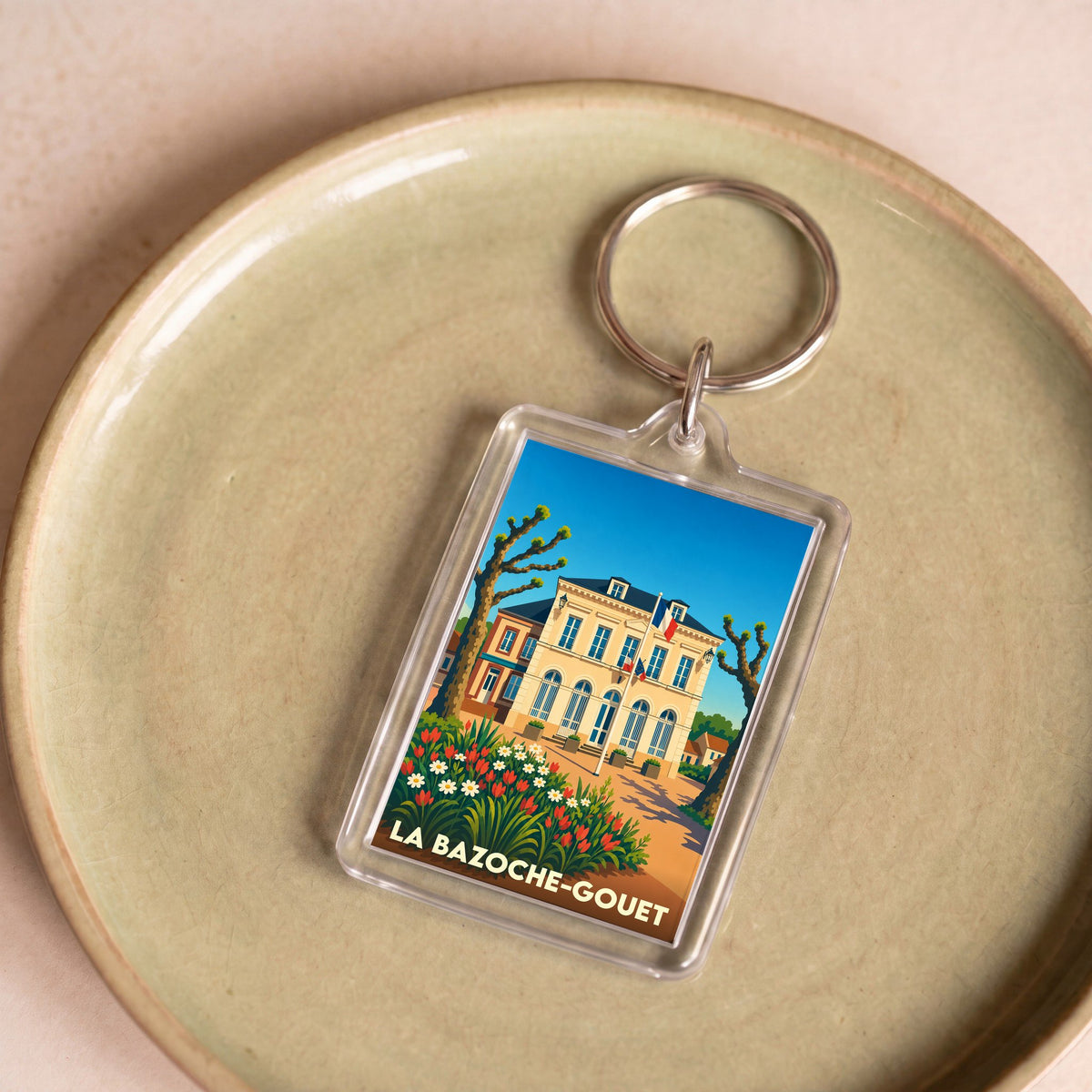Porte-clés souvenir de la ville de La Bazoche-Gouet avec une illustration stylisée.