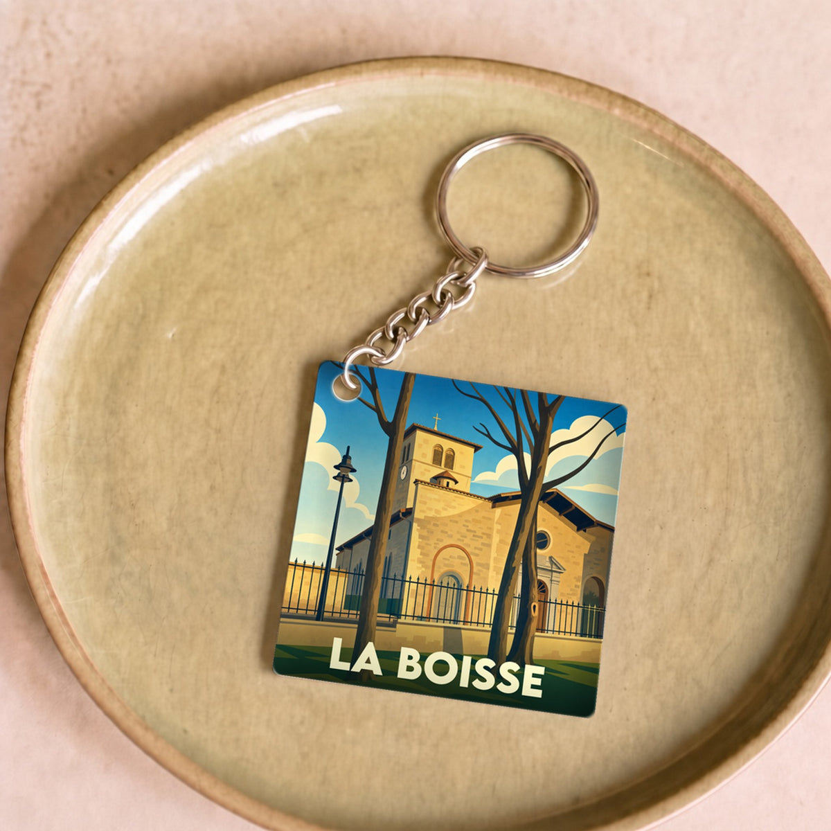 Porte-clés souvenir de la ville de La Boisse avec une illustration stylisée.