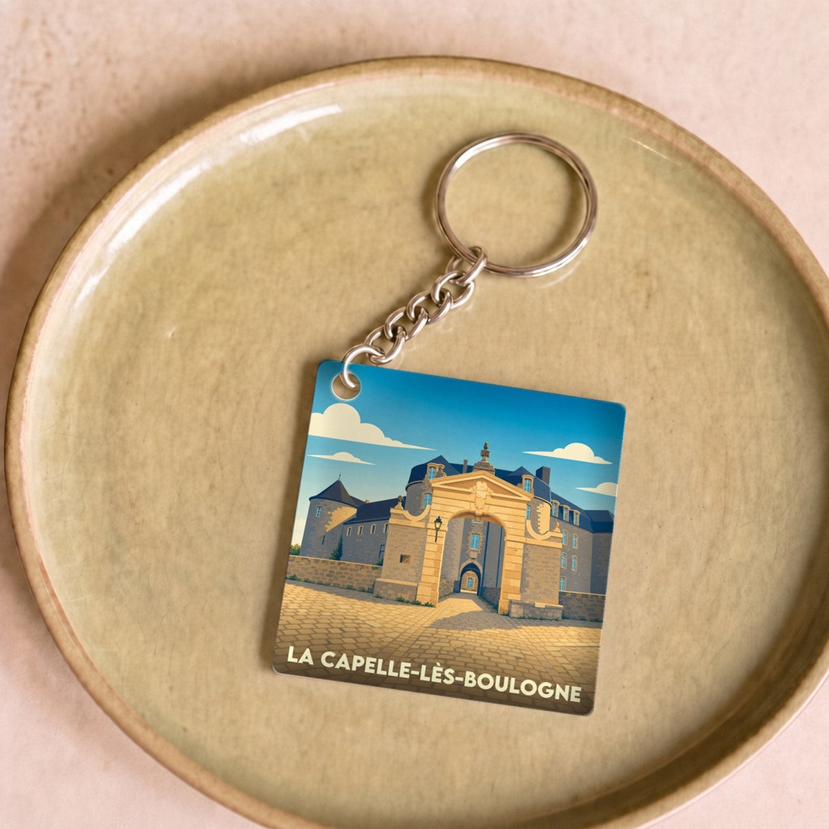 Porte-clés souvenir de la ville de La Capelle-lès-Boulogne avec une illustration stylisée.