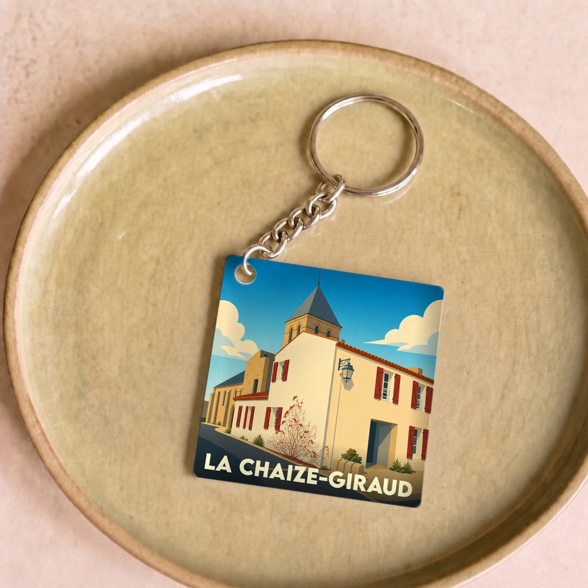 Porte-clés souvenir de la ville de La Chaize-Giraud avec une illustration stylisée.
