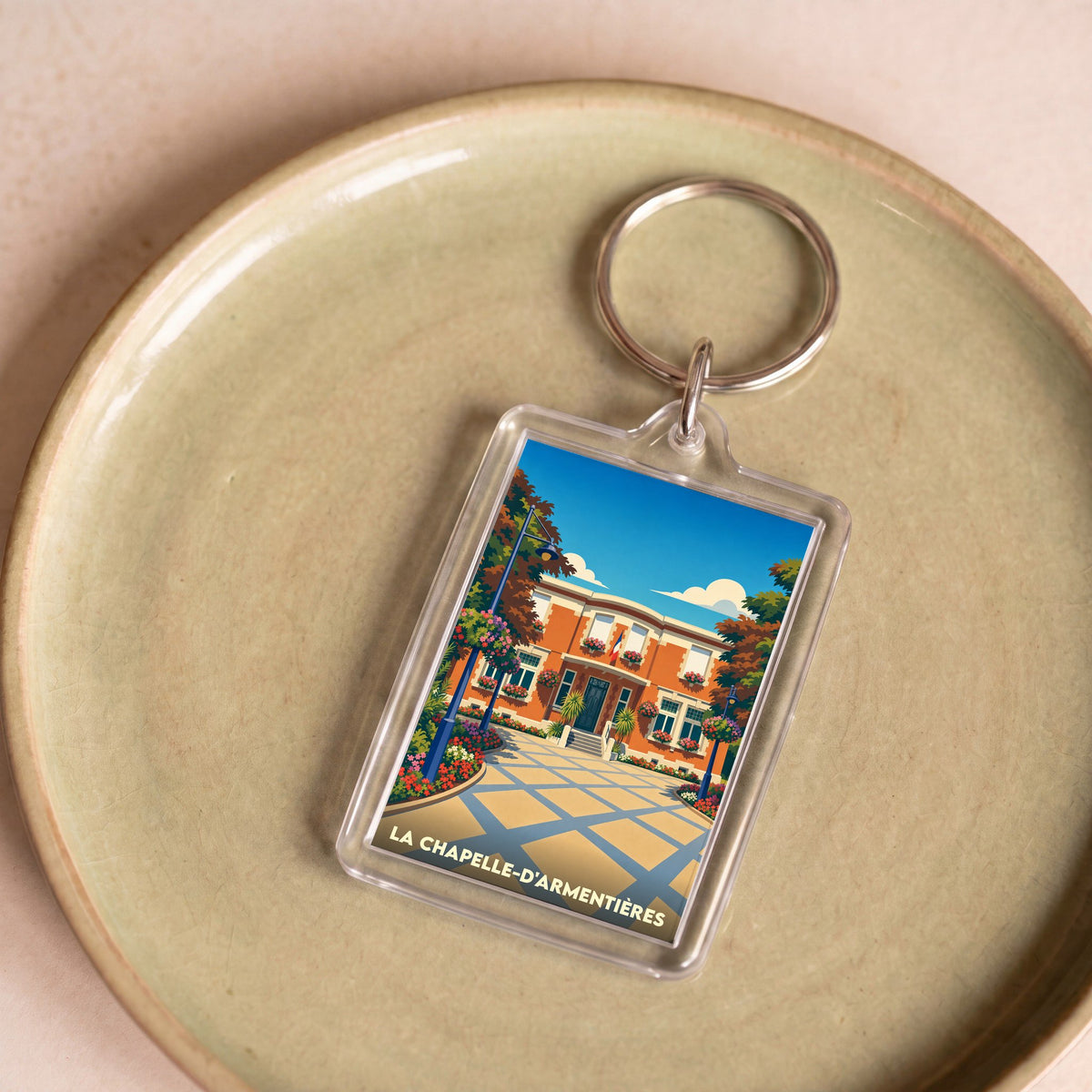 Porte-clés souvenir de la ville de La Chapelle-d'Armentières avec une illustration stylisée de l'hôtel de ville.