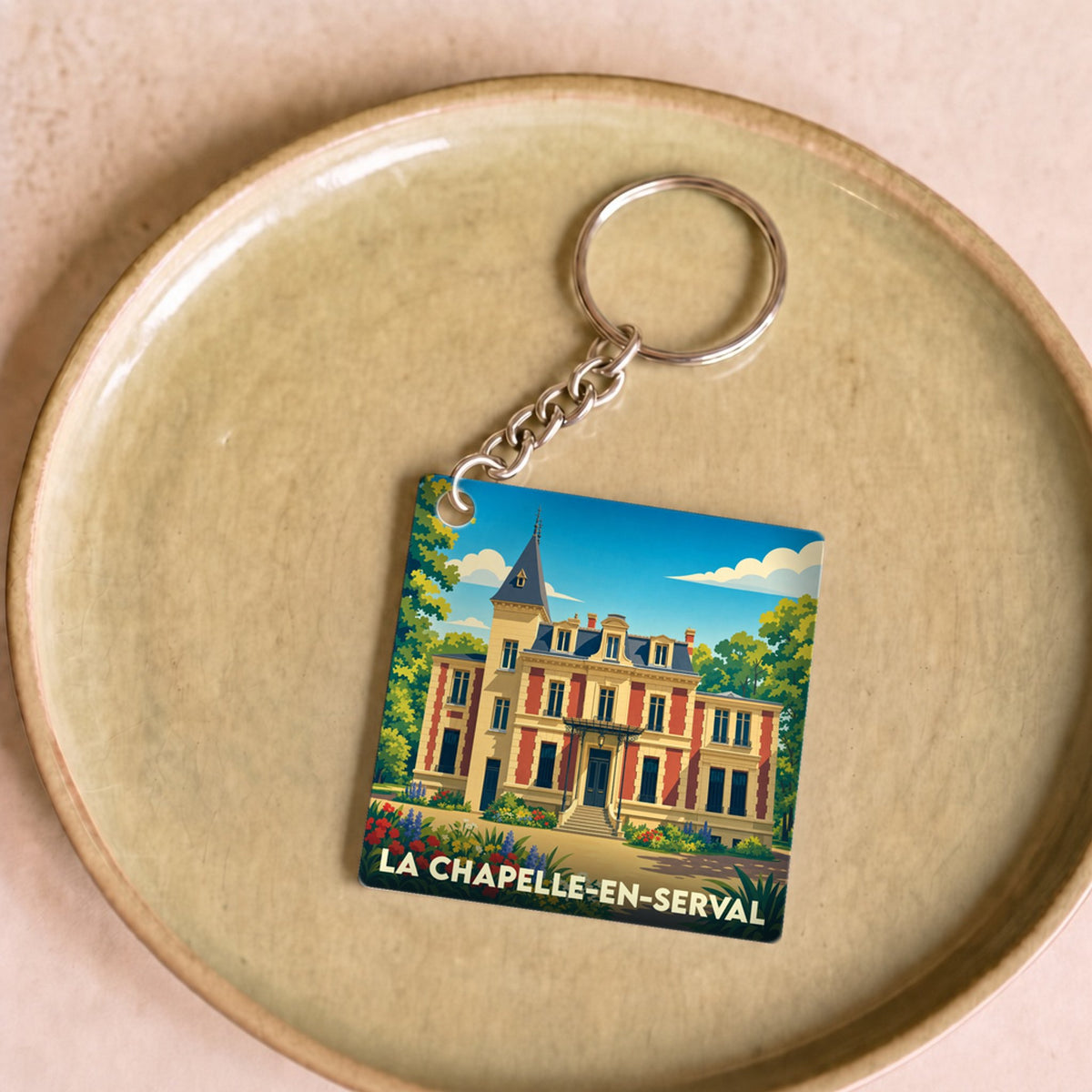 Porte-clés souvenir de la ville de La Chapelle-en-Serval avec une illustration stylisée.