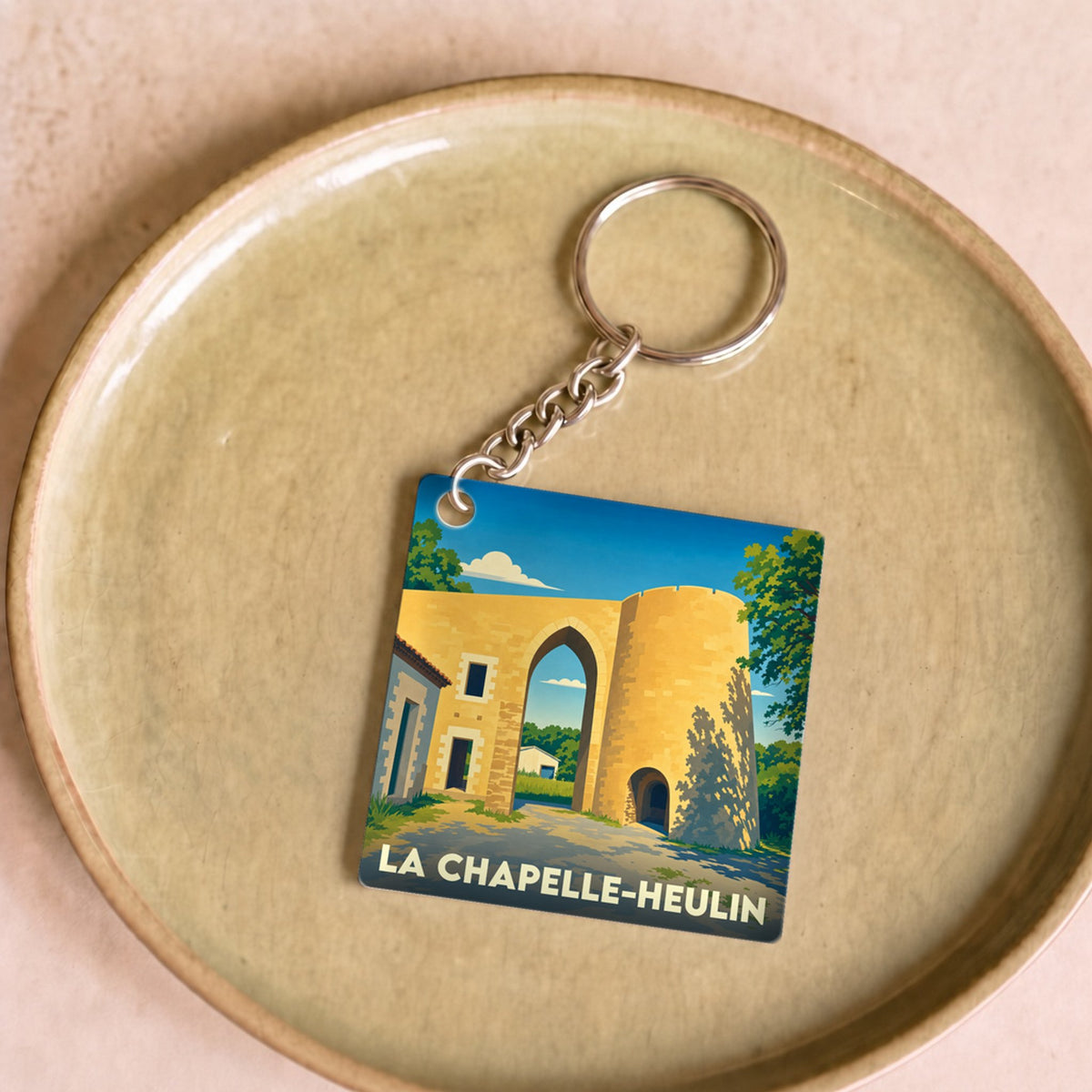 Porte-clés souvenir de la ville de La Chapelle-Heulin avec une illustration stylisée.