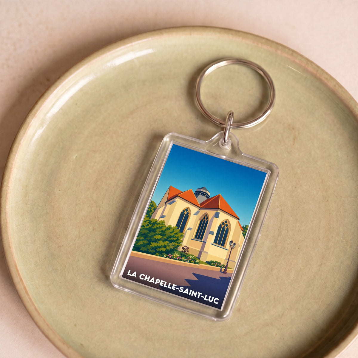 Porte-clés souvenir de la ville de La Chapelle-Saint-Luc avec une illustration stylisée.