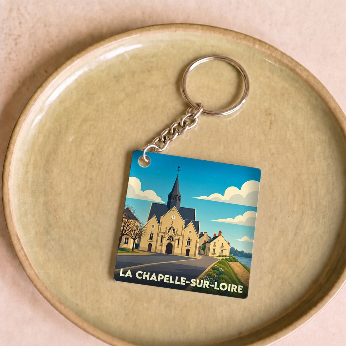 Porte-clés souvenir de la ville de La Chapelle-sur-Loire avec une illustration stylisée.
