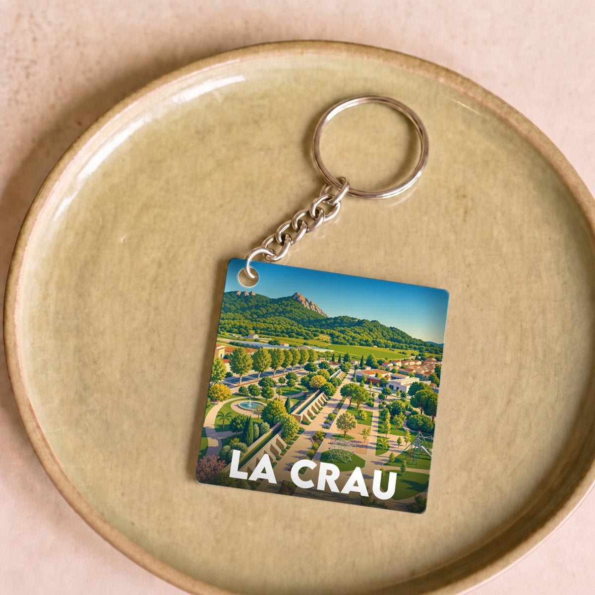 Porte-clés souvenir de la ville de La Crau avec une illustration stylisée.