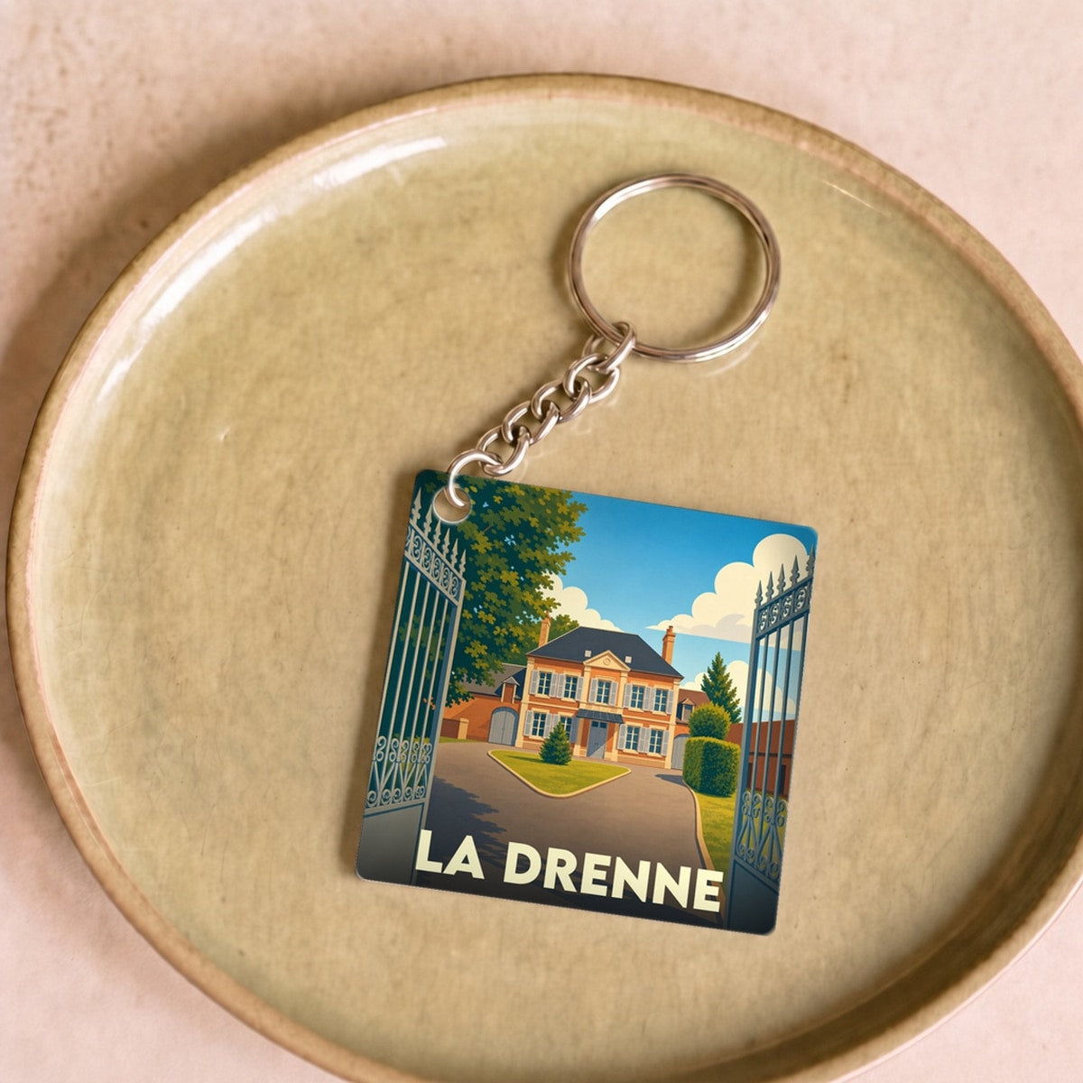 Porte-clés souvenir de la ville de La Drenne avec une illustration stylisée.