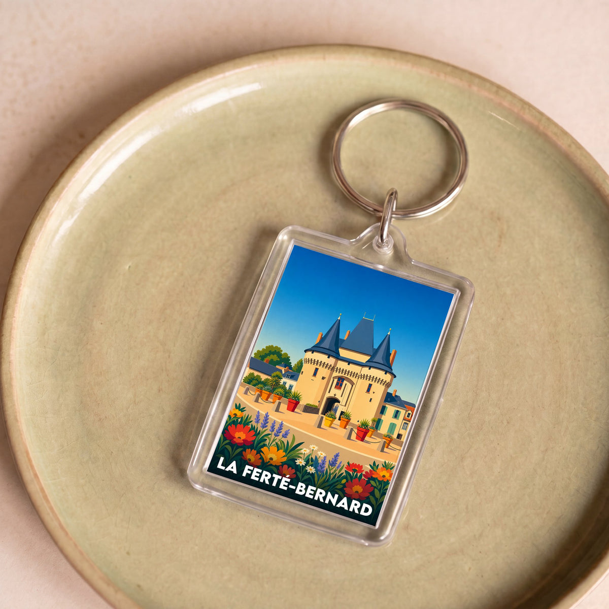 Porte-clés souvenir de la ville de La Ferté-Bernard avec une illustration stylisée.