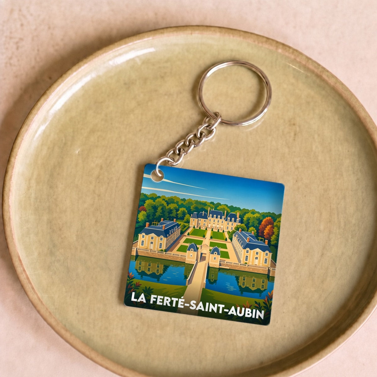 Porte-clés souvenir de la ville de La Ferté-Saint-Aubin avec une illustration stylisée de son château.