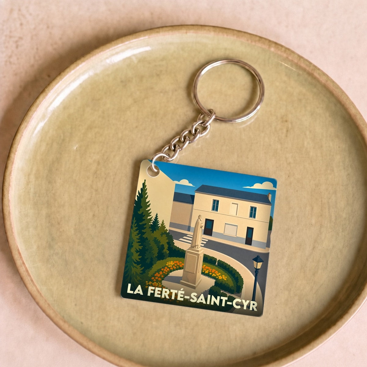Porte-clés souvenir de la ville de La Ferté-Saint-Cyr avec une illustration stylisée.