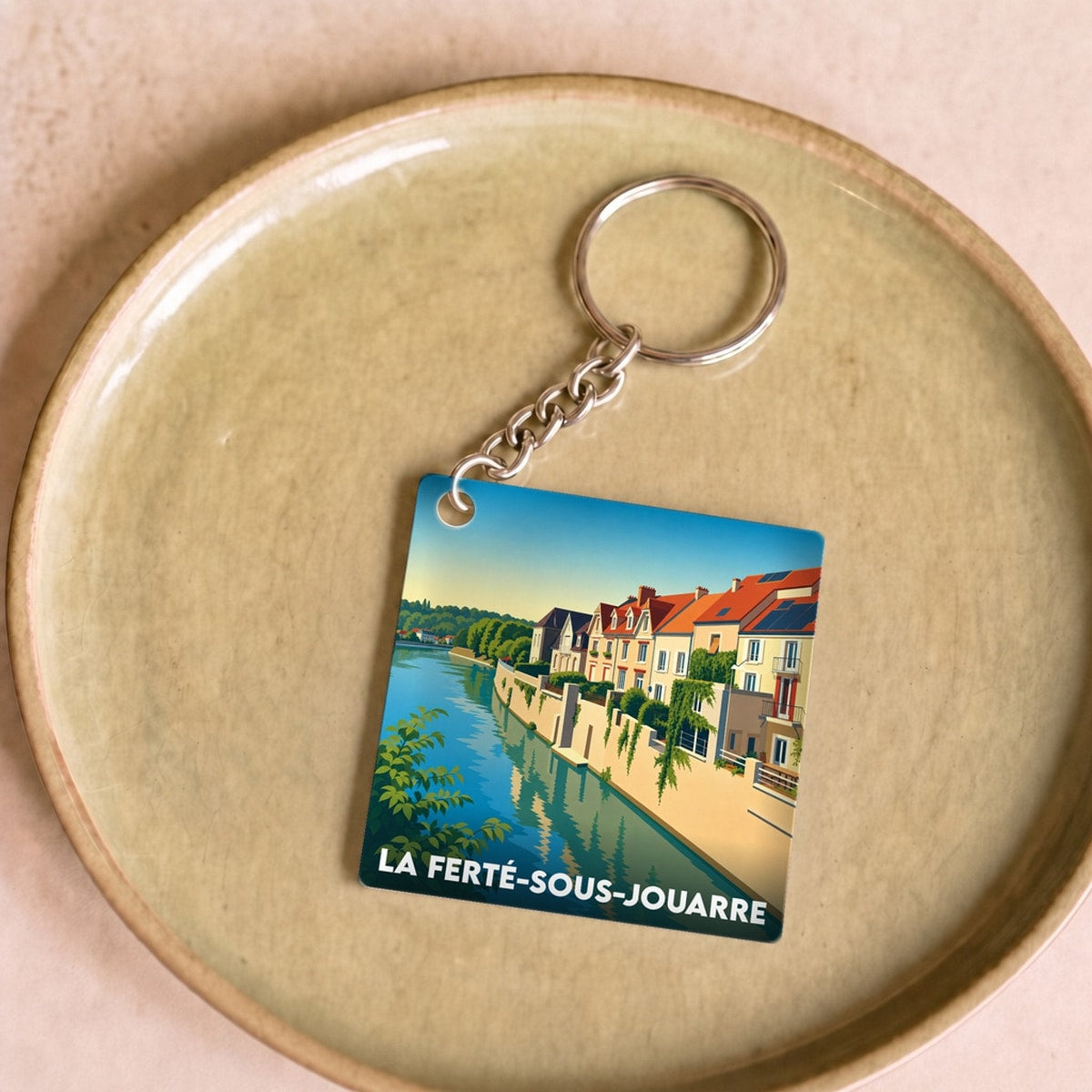 Porte-clés souvenir de la ville de La Ferté-sous-Jouarre avec une illustration stylisée.