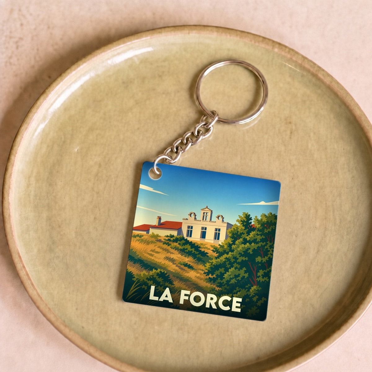 Porte-clés souvenir de la ville de La Force avec une illustration stylisée.