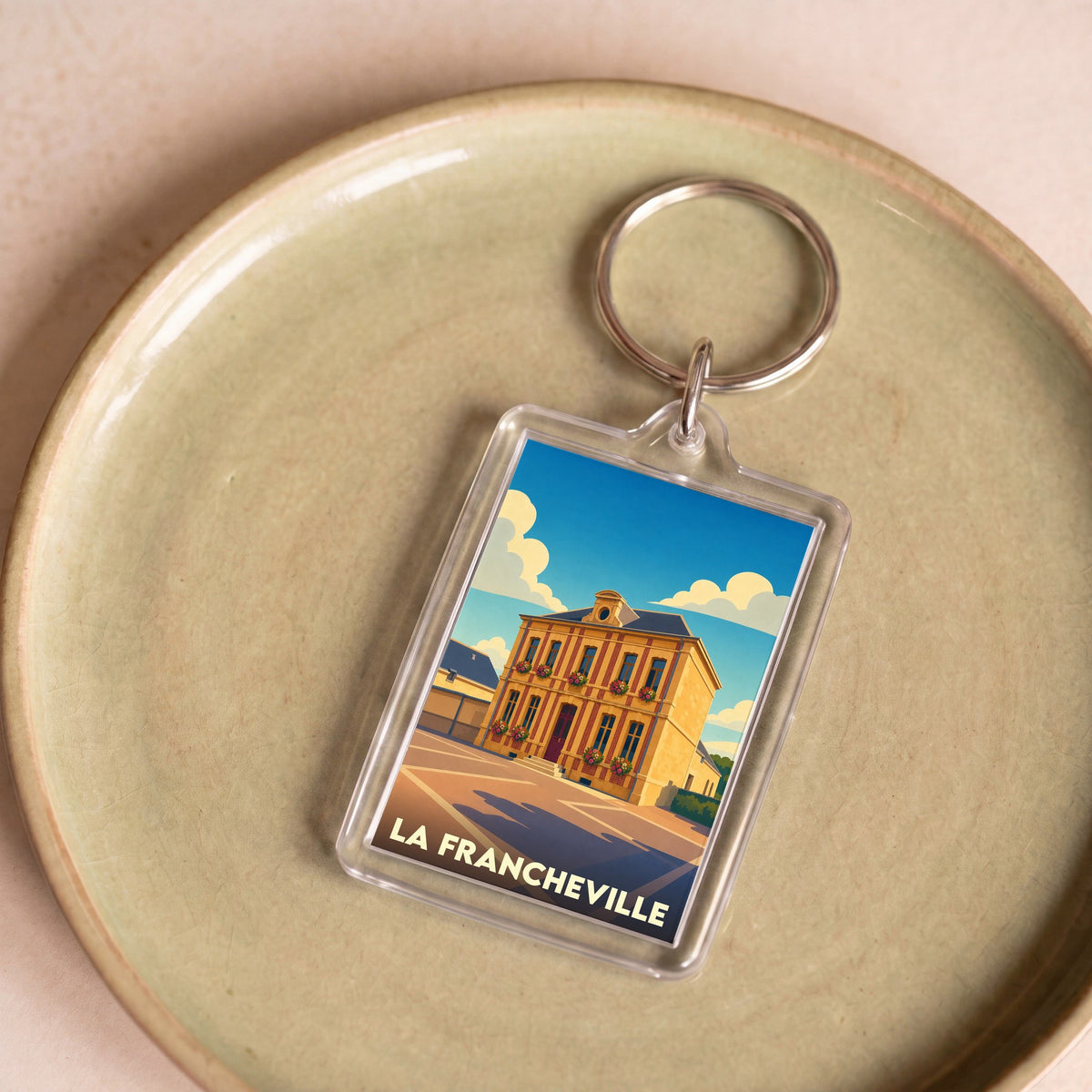 Porte-clés souvenir de la ville de La Francheville avec une illustration stylisée.