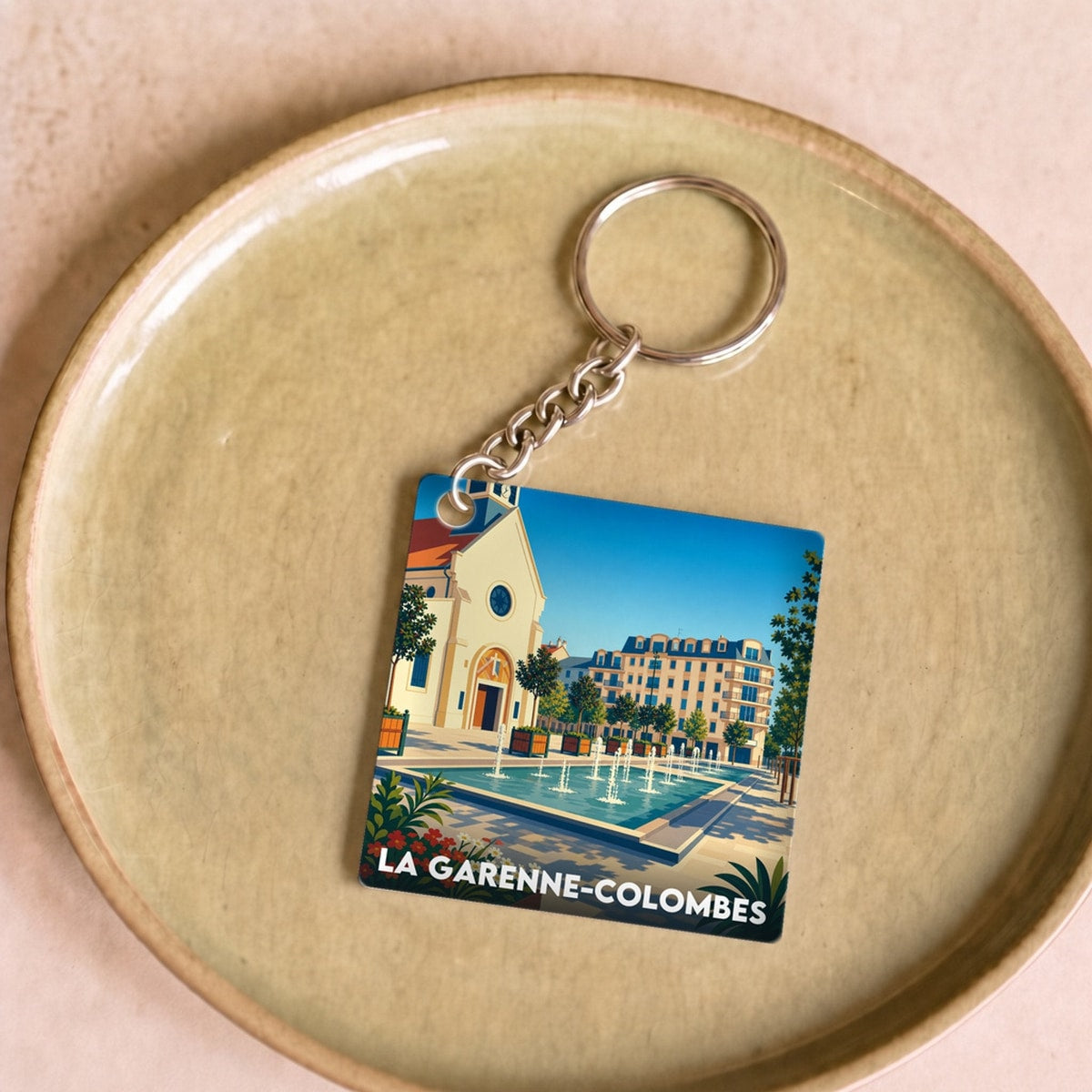 Porte-clés souvenir de la ville de La Garenne-Colombes avec une illustration stylisée.