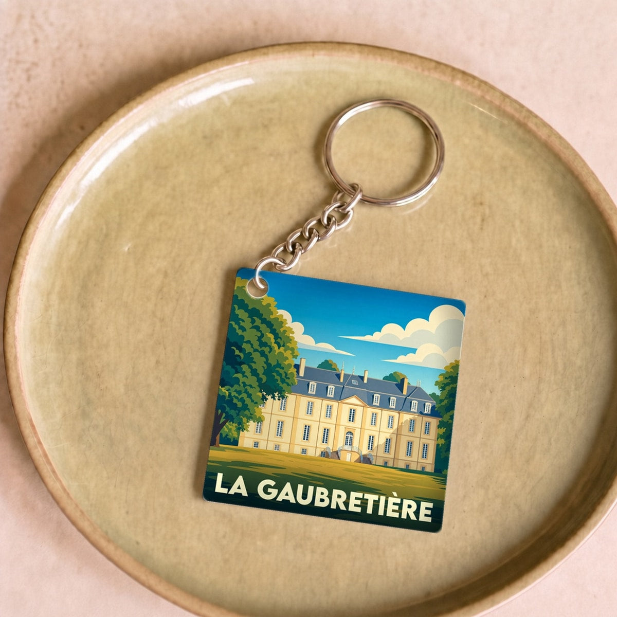 Porte-clés souvenir de la ville de La Gaubretière avec une illustration stylisée.