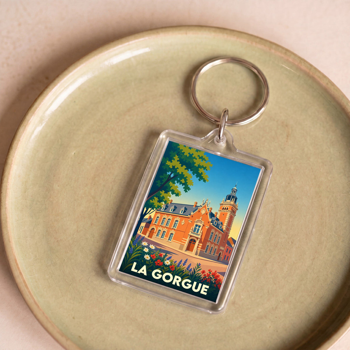 Porte-clés souvenir de la ville de La Gorgue avec une illustration stylisée de son hôtel de ville.