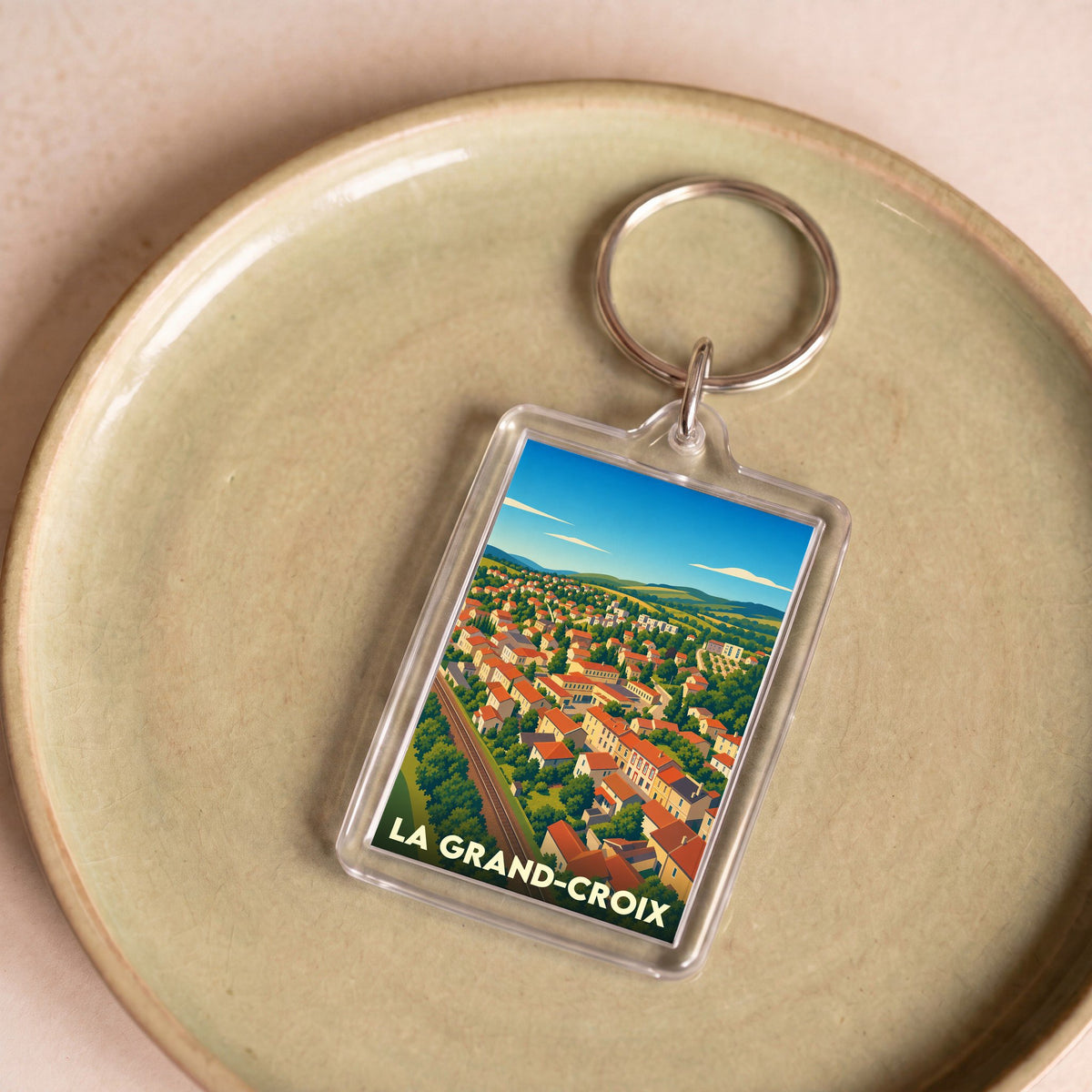 Porte-clés souvenir de la ville de La Grand-Croix avec une illustration stylisée.