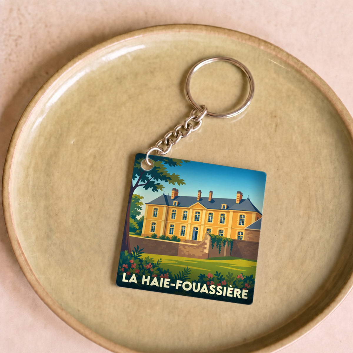 Porte-clés souvenir de la ville de La Haie-Fouassière avec une illustration stylisée.
