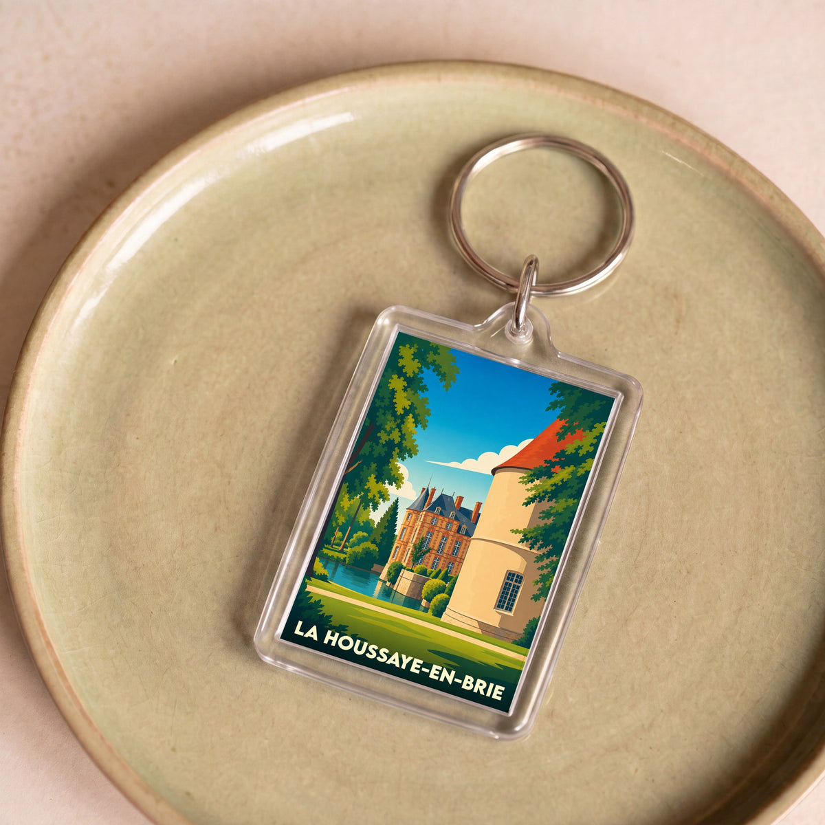 Porte-clés souvenir de la ville de La Houssaye-en-Brie avec une illustration stylisée de son château.