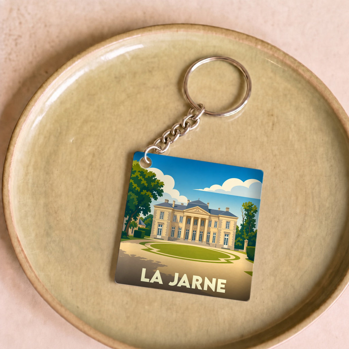 Porte-clés souvenir de la ville de La Jarne avec une illustration stylisée d'un château.