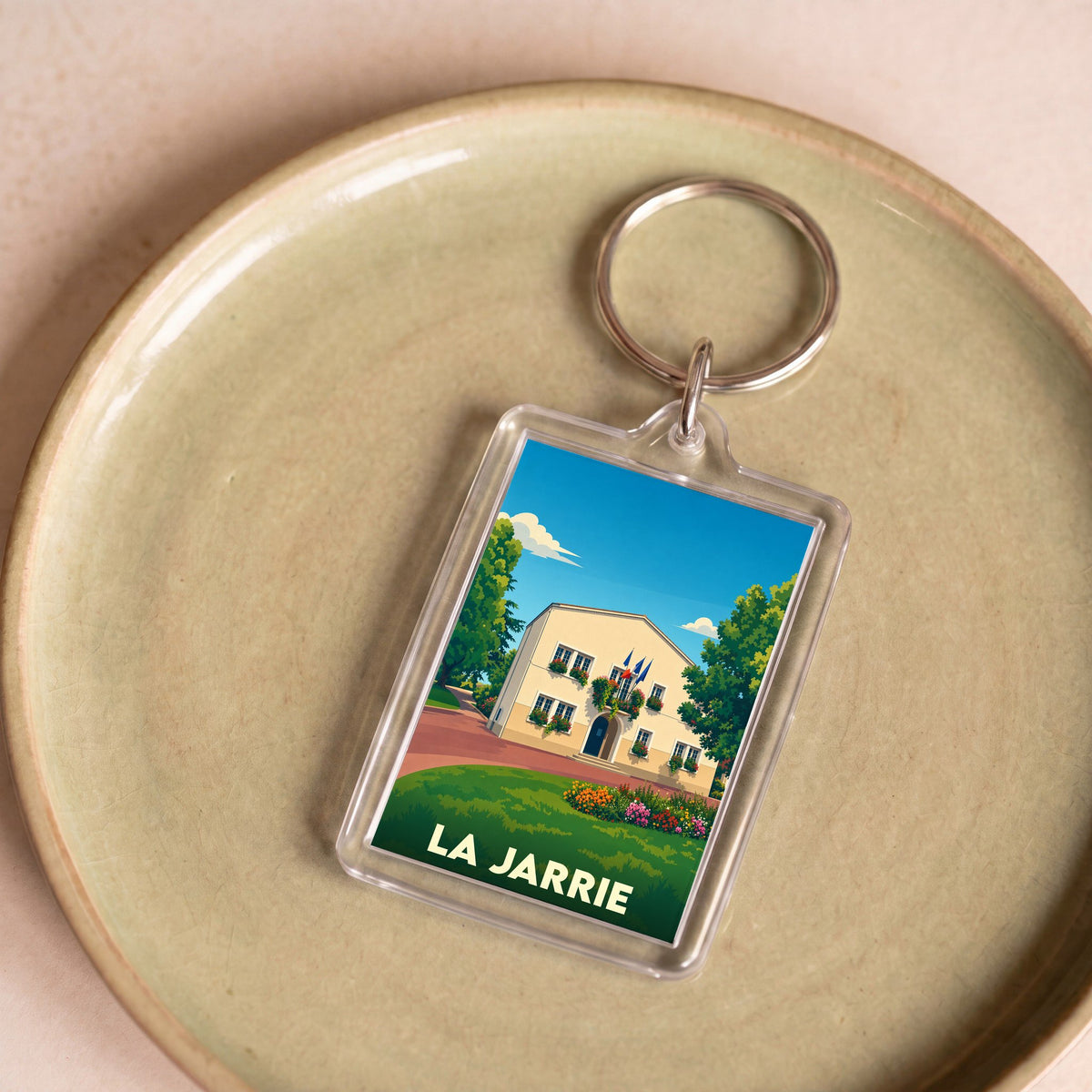 Porte-clés souvenir de la ville de La Jarrie avec une illustration stylisée de sa mairie.