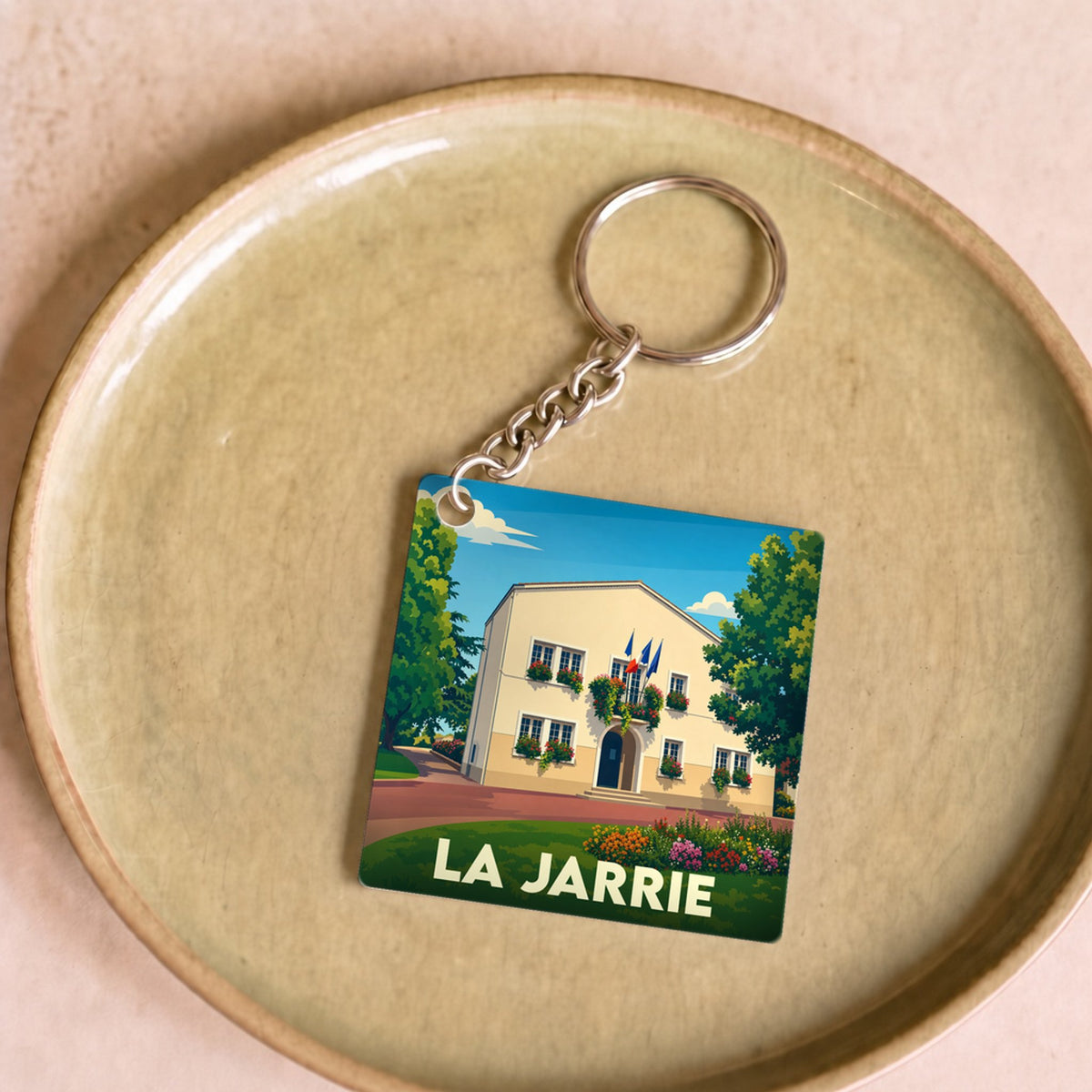 Porte-clés souvenir de la ville de La Jarrie avec une illustration stylisée de sa mairie.