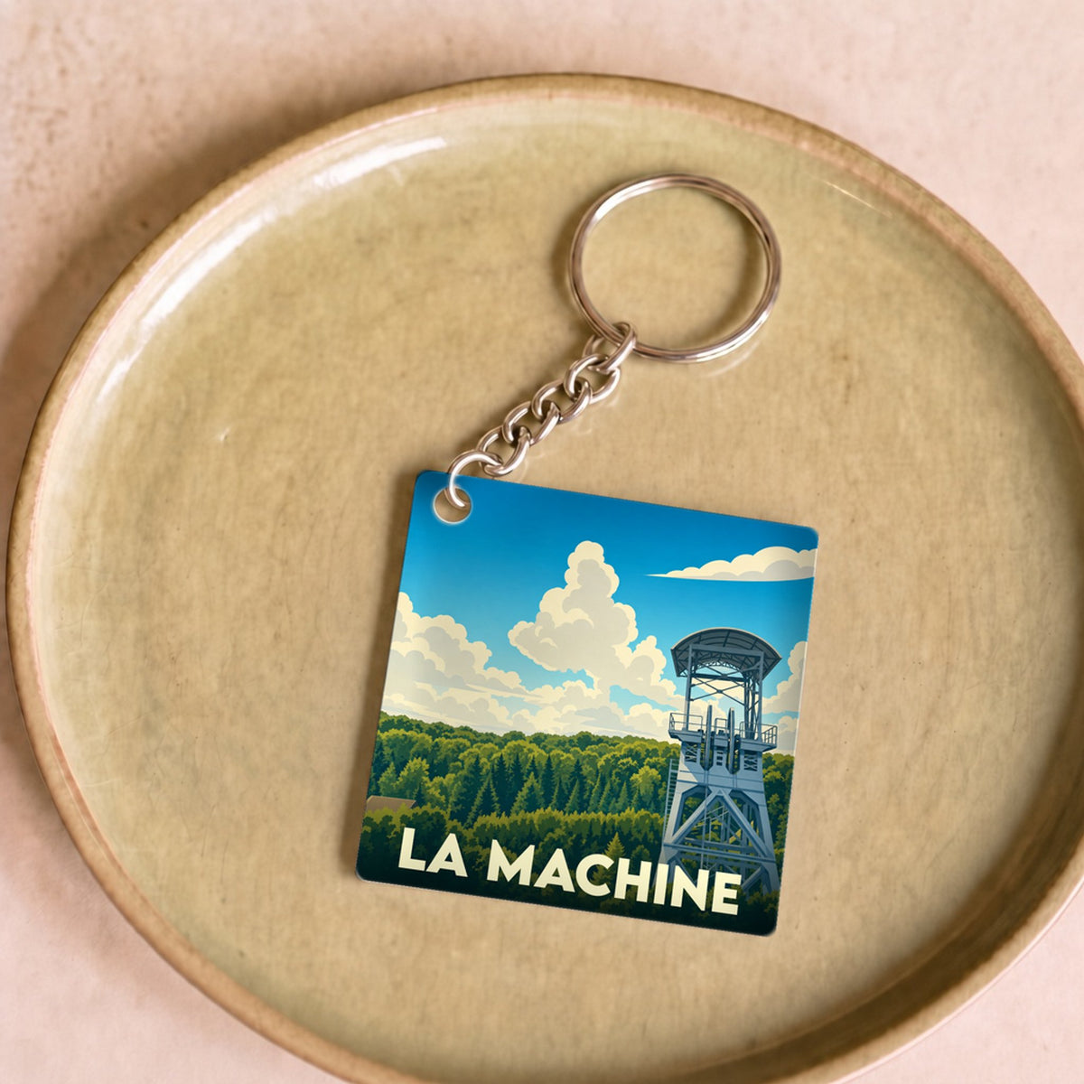 Porte-clés souvenir de la ville de La Machine avec une illustration stylisée d'un chevalement de mine.