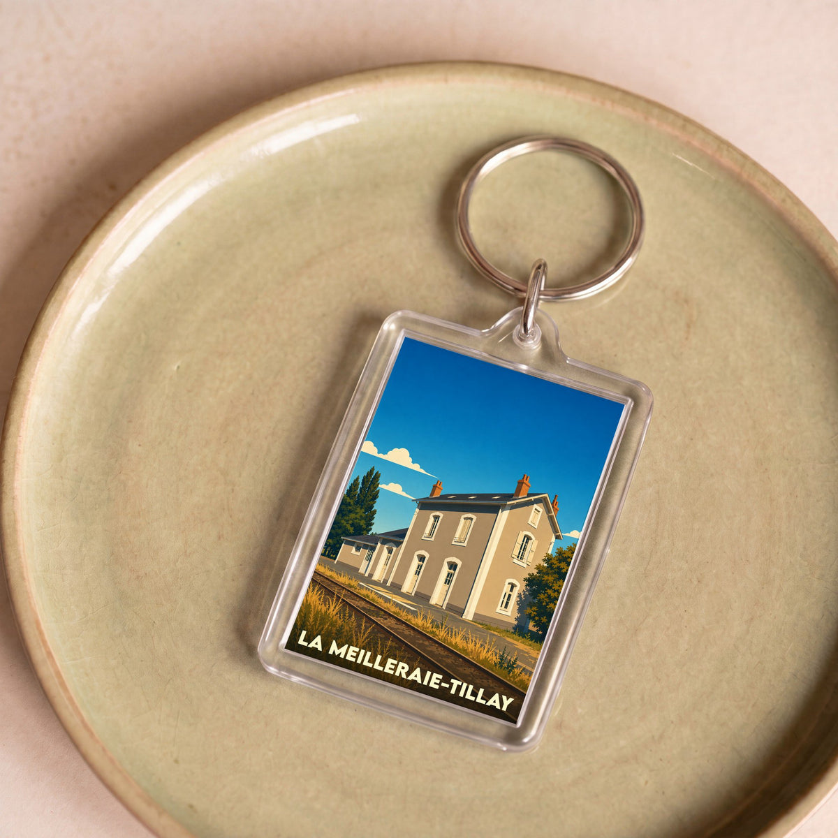 Porte-clés souvenir de la ville de La Meilleraie-Tillay avec une illustration stylisée.