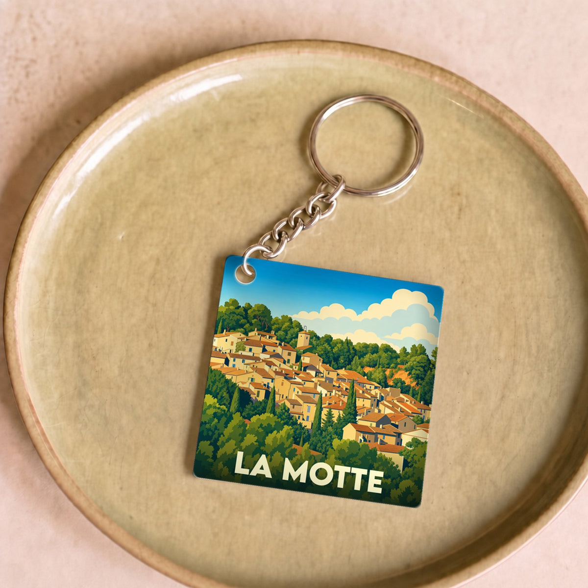 Porte-clés souvenir de la ville de La Motte avec une illustration stylisée.