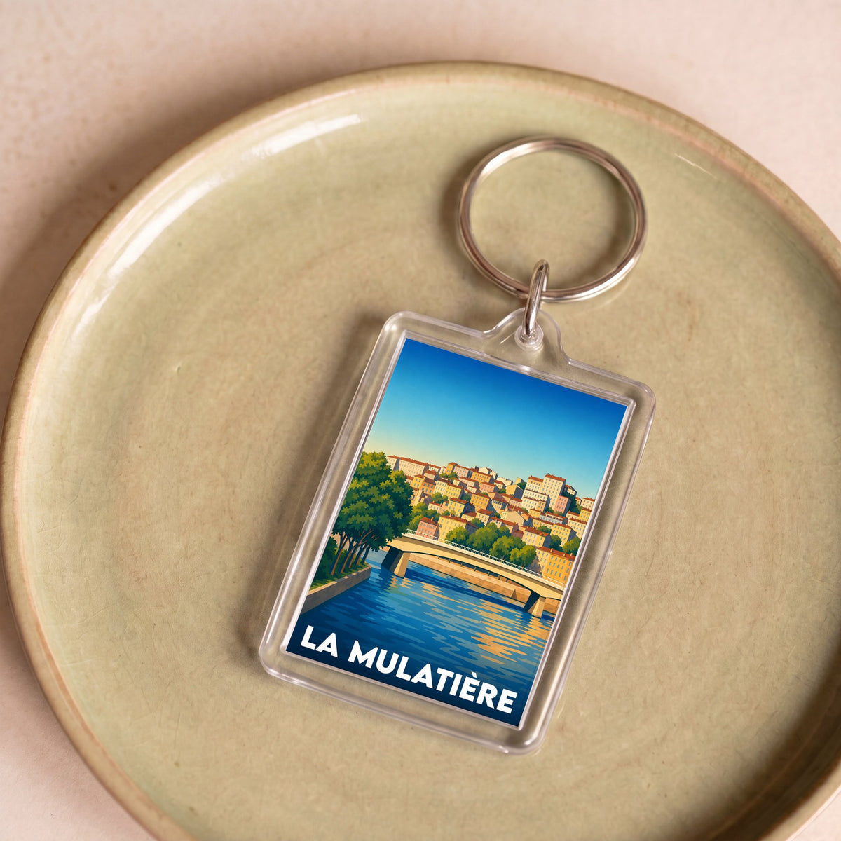 Porte-clés souvenir de la ville de La Mulatière avec une illustration stylisée.