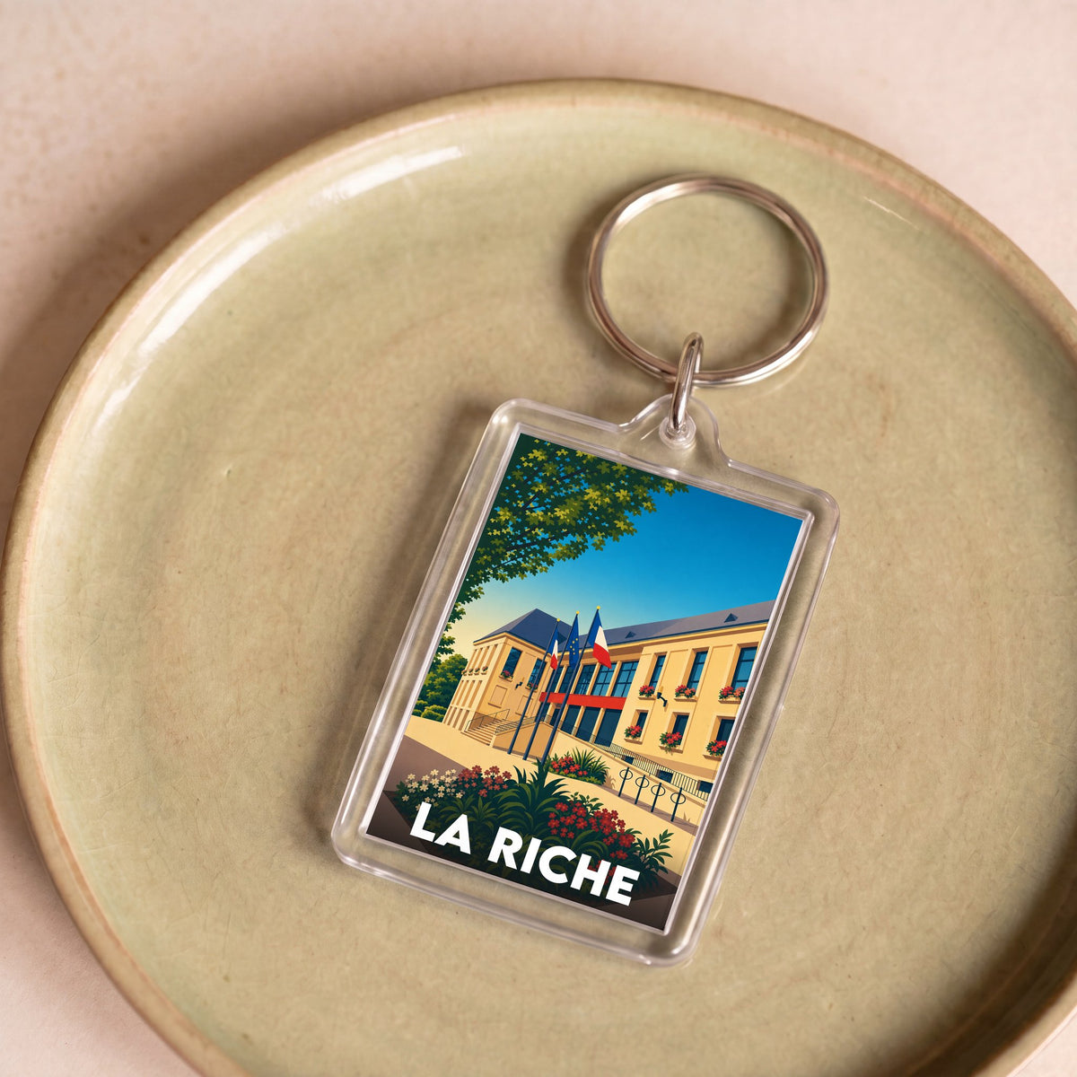 Porte-clés souvenir de la ville de La Riche avec une illustration stylisée.