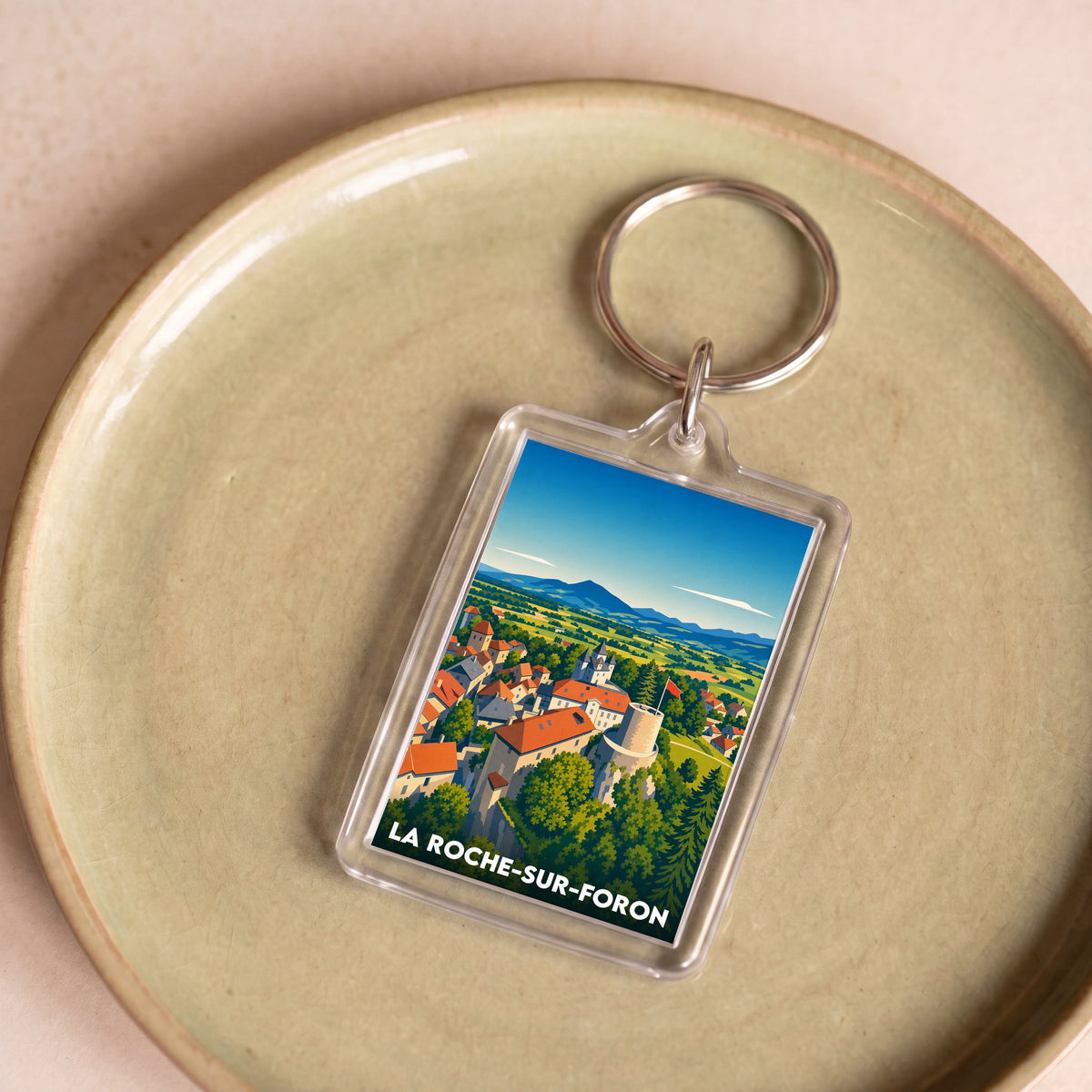 Porte-clés souvenir de la ville de La Roche-sur-Foron avec une illustration stylisée.