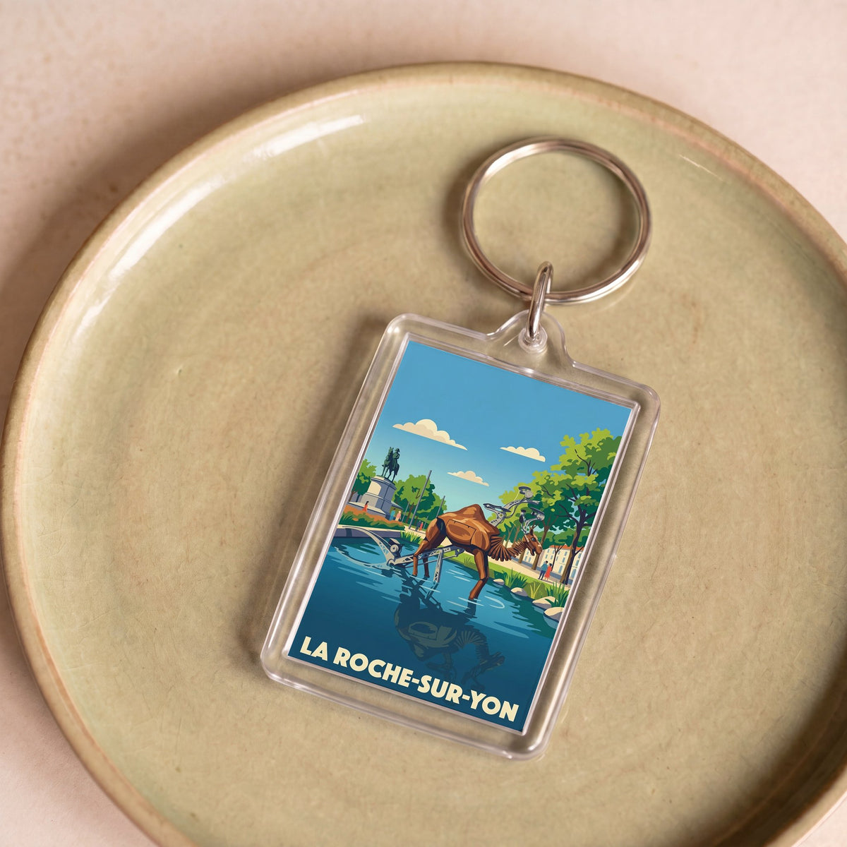 Porte-clés souvenir de la ville de La Roche-sur-Yon avec une illustration stylisée.