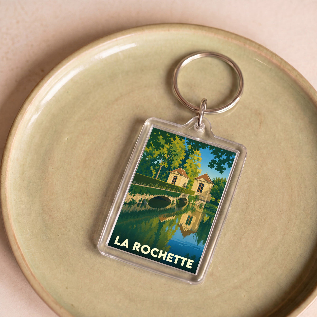 Porte-clés souvenir de la ville de La Rochette avec une illustration stylisée.