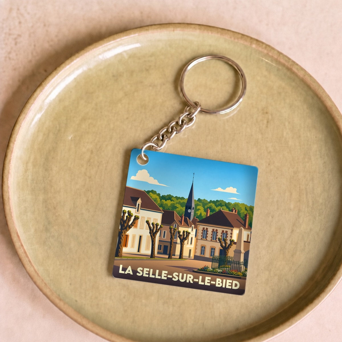 Porte-clés souvenir de la ville de La Selle-sur-le-Bied avec une illustration stylisée.