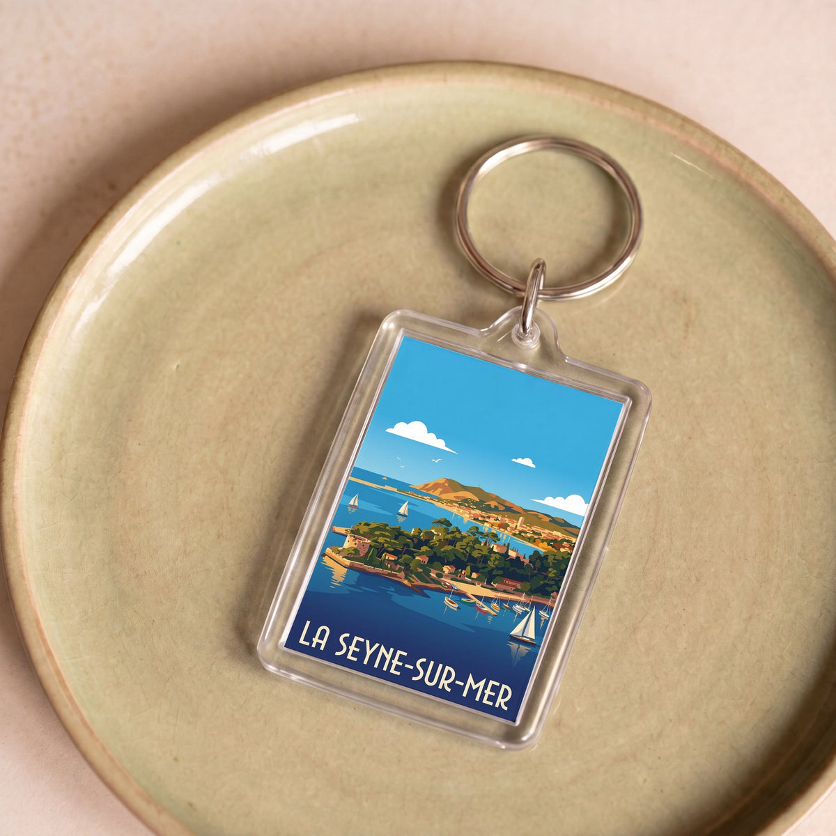 Porte-clés souvenir de la ville de La Seyne-sur-Mer avec une illustration stylisée.