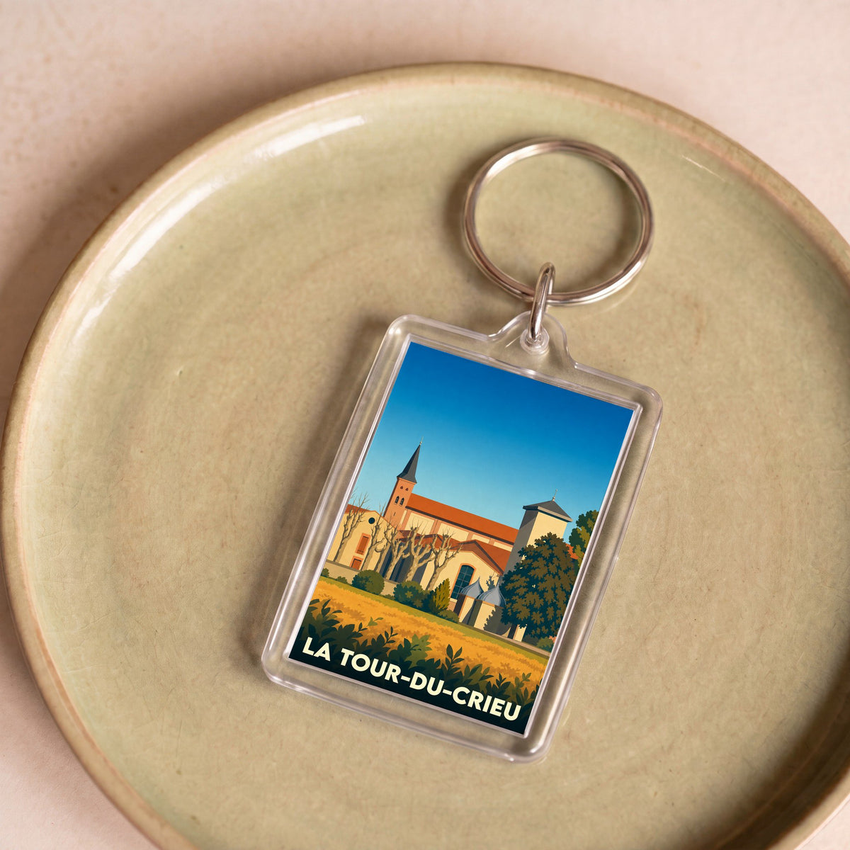 Porte-clés souvenir de la ville de La Tour-du-Crieu avec une illustration stylisée.