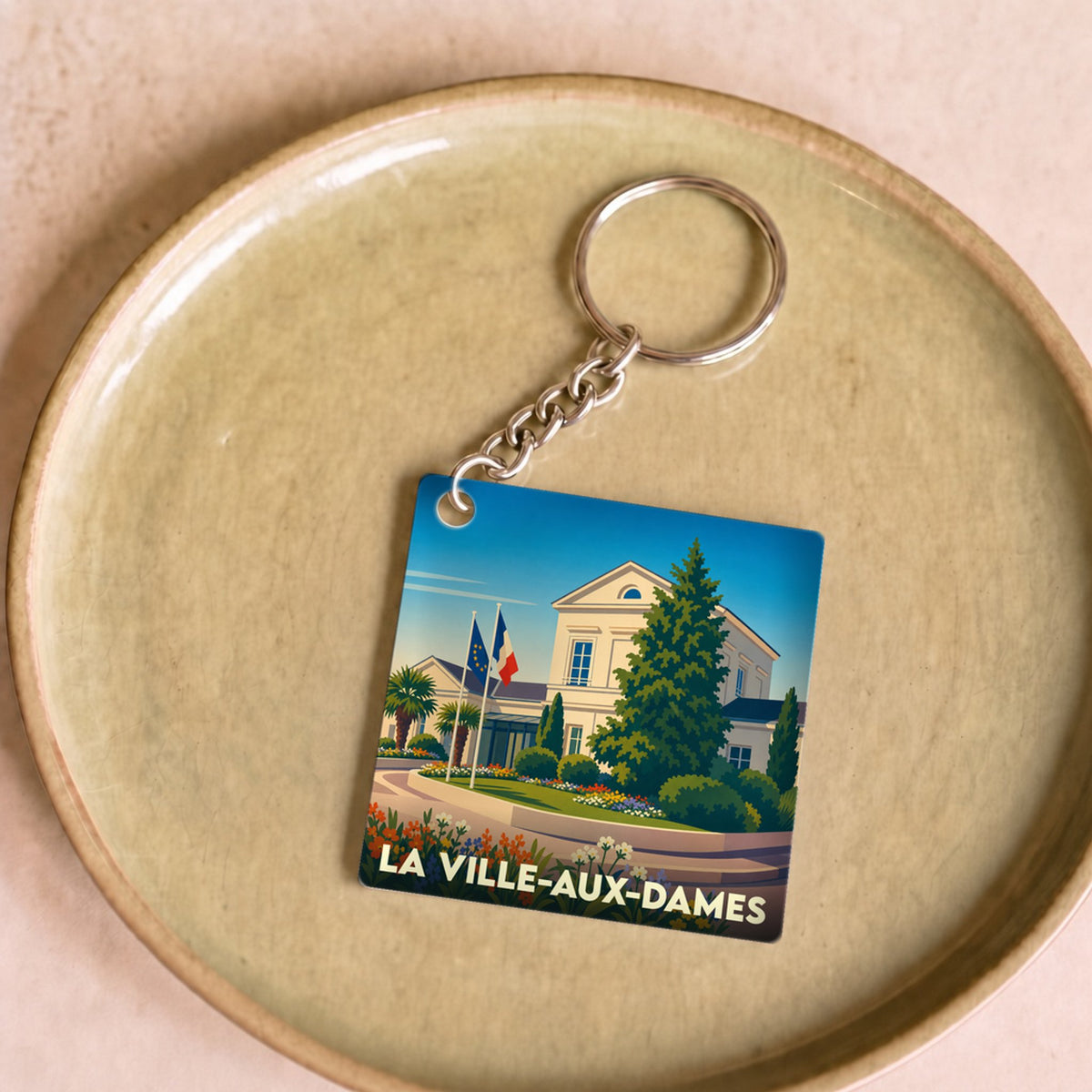 Porte-clés souvenir de la ville de La Ville-aux-Dames avec une illustration stylisée de l'hôtel de ville.