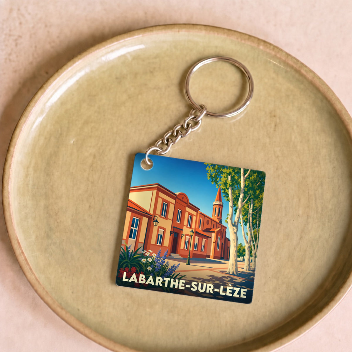 Porte-clés souvenir de la ville de Labarthe-sur-Lèze avec une illustration stylisée.