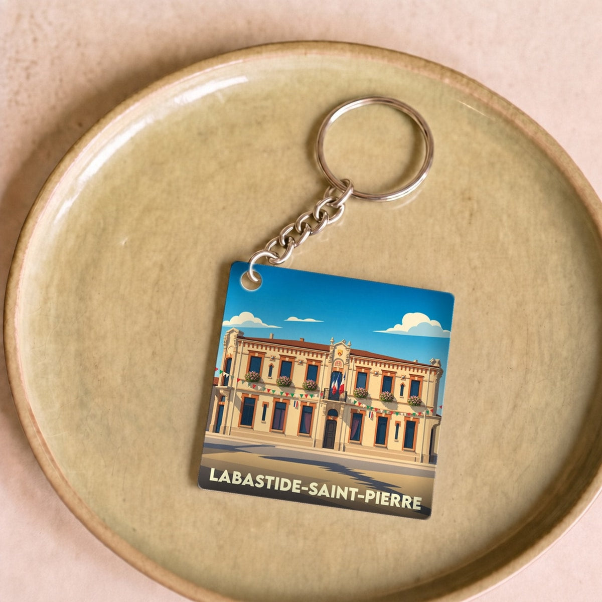 Porte-clés souvenir de la ville de Labastide-Saint-Pierre avec une illustration stylisée.