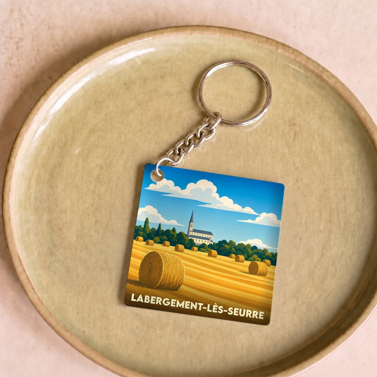 Porte-clés souvenir de la ville de Labergement-lès-Seurre avec une illustration stylisée d'un champ de blé.