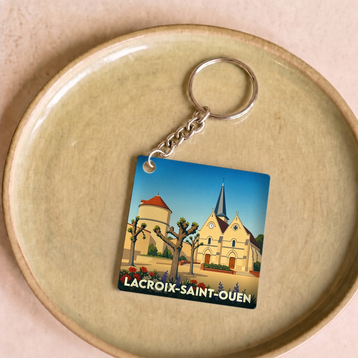 Porte-clés souvenir de la ville de Lacroix-Saint-Ouen avec une illustration stylisée.